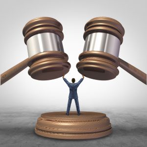 Mediation resolution and mediate legal disputes in business as a concept with a businessman or lawyer separating two judge mallets or gavel as competitors in arbitration.