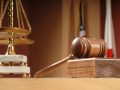 Legal concept still life in a courtroom with American and Californian flags in the background