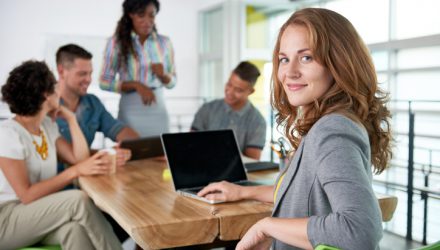 Creative blond businesswoman leading hes team in a friendly conversation about their next agency project